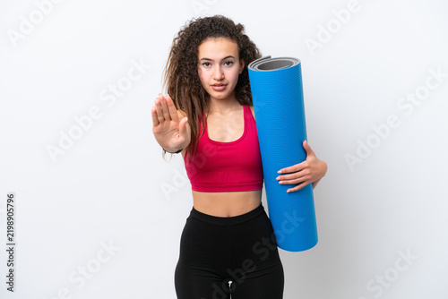 Konstfotografi Young sport Arab woman going to yoga classes while holding a mat isolated on whi