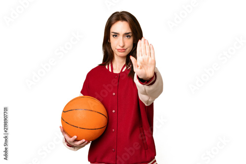 Cuadro en lienzo Young basketball player woman over isolated chroma key background making stop ge