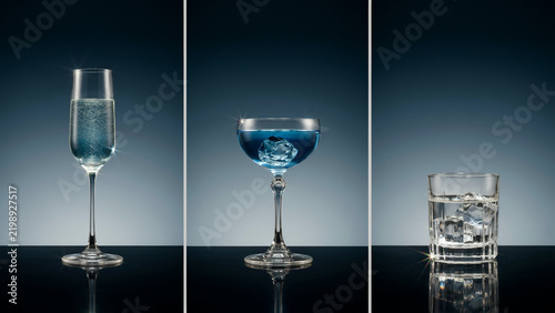Three distinct glassware pieces containing blue liquid and ice cubes on reflective surface