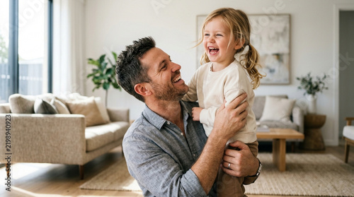 Father Holding Laughing Daughter Indoors - Happy Family Moments