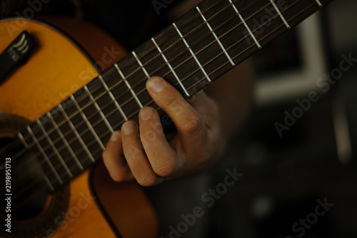 Playing the guitar. Close up. 