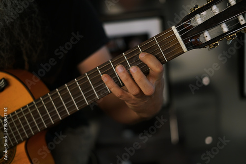 Playing the guitar. Close up. 