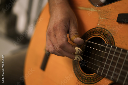 Playing the guitar. Close up. 