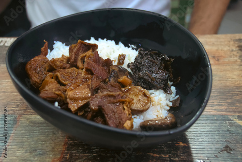 Obraz na płótnie A close-up of braised beef (Ngau Lam) with chu hou paste, fermented spinach and rice, local Cantonese dish served in street side food stall (dai pai dong)