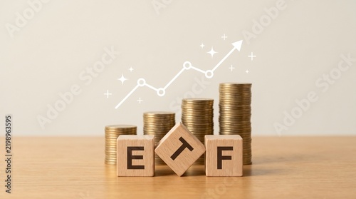 ETF Exchange Traded Fund Investment Concept with Wooden Blocks and Stacks of Coins with Growing Graph