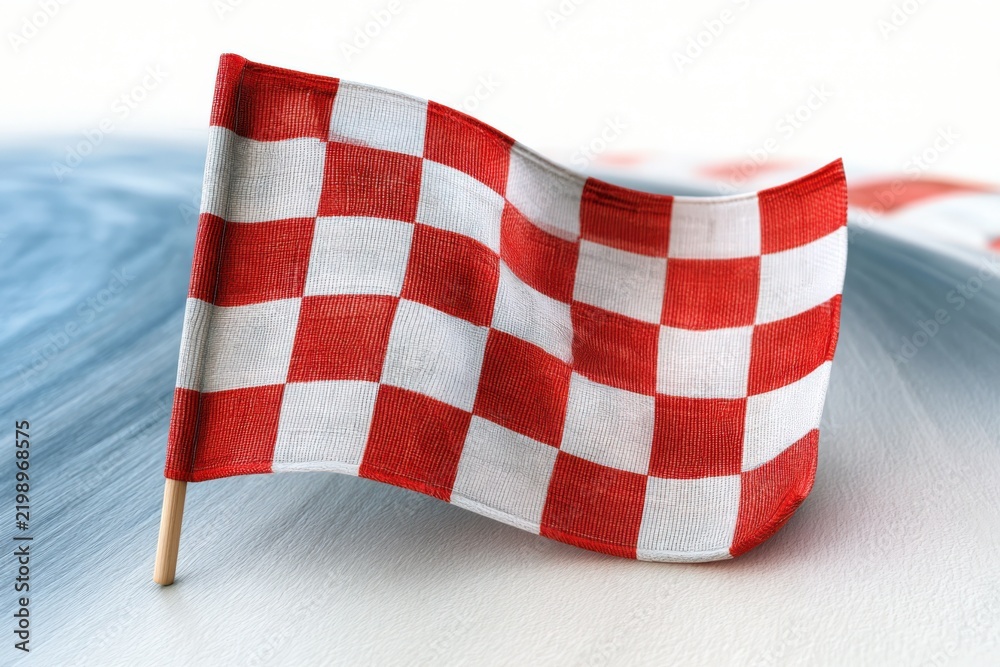 Obraz premium Red and white checkered flag waves gently on a stick