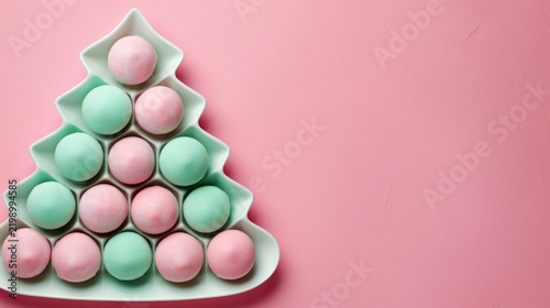Colorful Pastel Macarons Arranged in Christmas Tree Shape on Pink Background