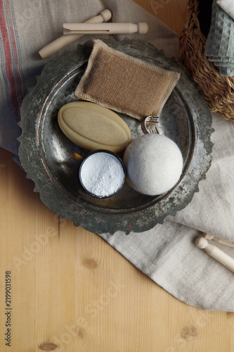 A basket with stacked laundry and clothespins