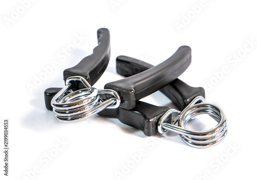 A pairs of black hand grip strengthener with a metal torsion spring, isolated on a clean white background. Designed for wrist, hand, and forearm exercise.