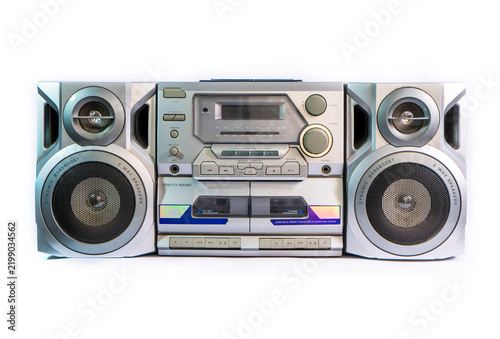 Retro 90s audio tape recorder and mini hi-fi system with radio tuner and dual cassette deck, isolated on an empty white background.