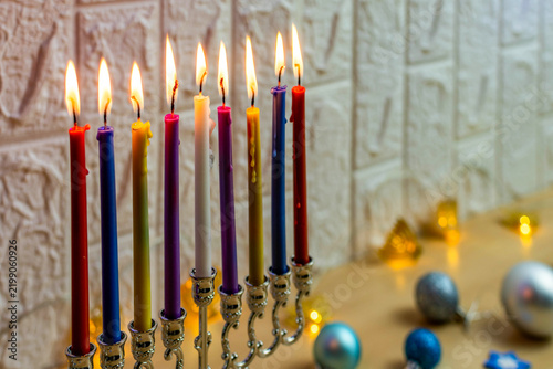 Fotografie Hanukkah menorah with colorful lit candles representing tradition