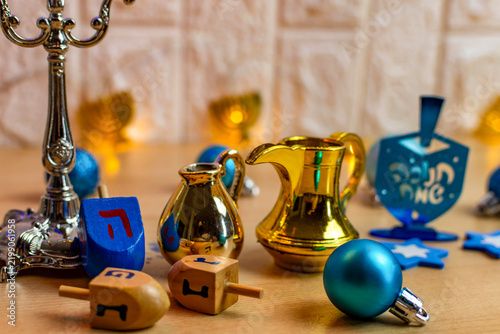 Obraz na plátně Hanukkah celebration with dreidels, menorah, and golden oil jars
