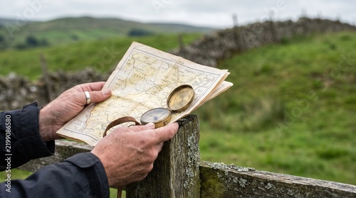 Hands holding a map and compass