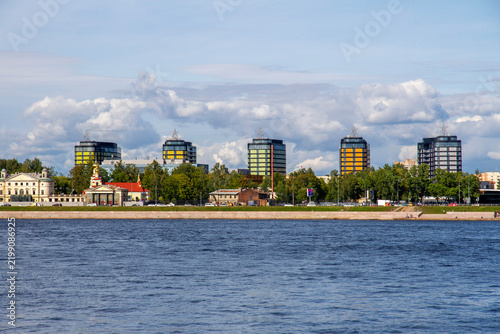 Fotografía Sunny day view of Sverdlovskaya embankment and Neva River with modern high-rise buildings in Saint Petersburg, Russia