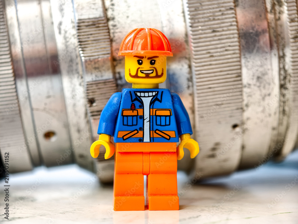 Obraz premium Russia, St. Petersburg, August 8, 2020 A close up of a Lego man wearing a hard hat, suitable for illustrations of construction or DIY projects