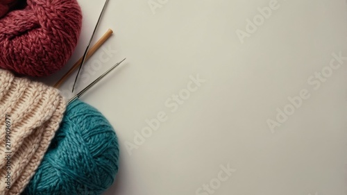 Knitting Supplies and Tools Arranged on a Plain Surface for Crafting Projects