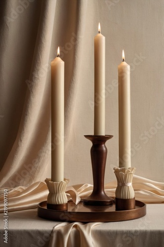Candles Placed on a Wooden Holder Surrounded by Soft Fabric and a Warm Atmosp...