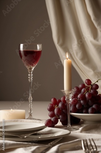 Wine and Candlelight Setup With Grapes on a Table