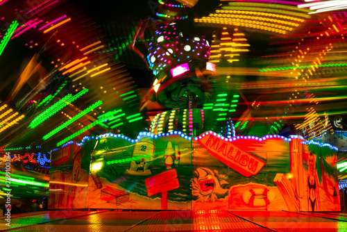 Dynamic Motion Blur and Neon Glow of a Fast Spinning Fairground Ride