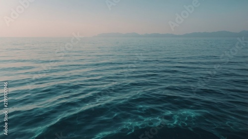 Clear Water With Gentle Waves in a Vast Ocean Under a Cloudy Sky