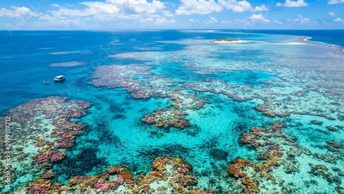 Aerial view of tropical beach with white sand turquoise water and lush forest