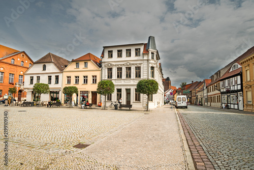 Wide view across a cobblestone market square surrounded by historic buildings in the old town, photographed in landscape format.