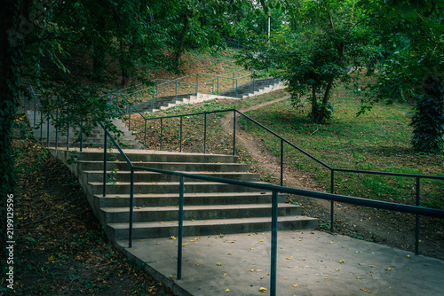 Concrete staircase with green railings in Parcul Tineretului park, Bucharest.