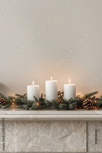 Decorative Candles With Greenery and Pine Cones on a Mantelpiece During the H...