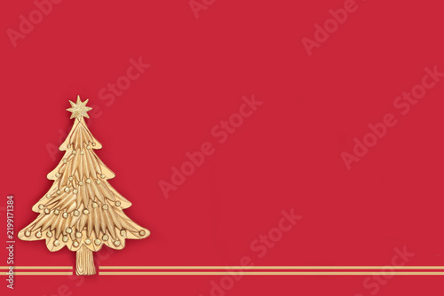 Gold Christmas tree vintage decoration design on red background. Minimal fantasy theme for festive holiday season with lines.