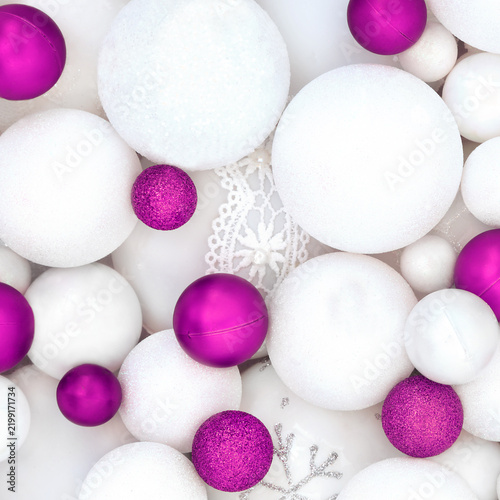 Purple white red Christmas sparkling tree decorations with sphere shape balls background. Festive symbols for the holiday season greeting card