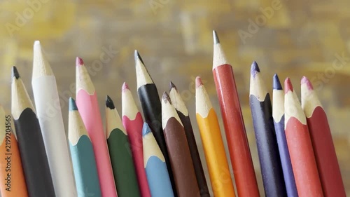 Row of multi colored wooden pencils standing together showing sharp tips. Creative drawing, school supplies, art education.