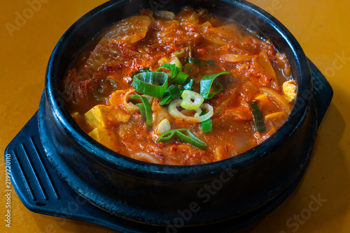 Top-Down View of Rich Korean Kimchi Stew in Black Earthenware Pot