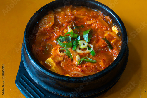 Top-Down View of Rich Korean Kimchi Stew in Black Earthenware Pot
