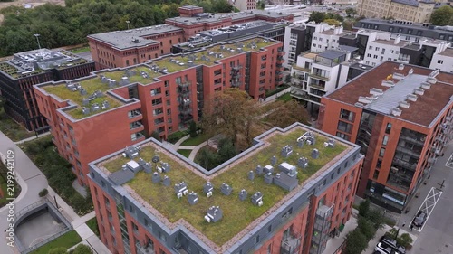 Aerial view of modern eco-friendly residential buildings with green roofs