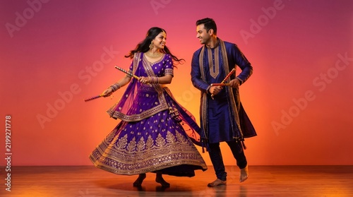Couple in traditional ethnic attire dancing with sticks garba dance navratri festival folk dance