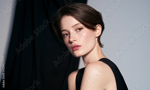 Portrait of young woman with short hair and natural makeup for beauty