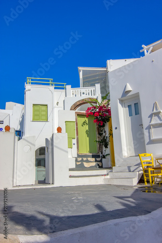 A sunlit traditional courtyard in Megalochori, Santorini.