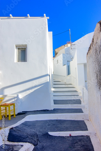 A narrow pedestrian alley in the traditional village of Megalochori on Santorini, Greece.