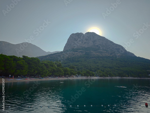 Majestic Biokovo Mountain towering over a tranquil Croatian beach, evoking serene escape, natural beauty, and peaceful travel.