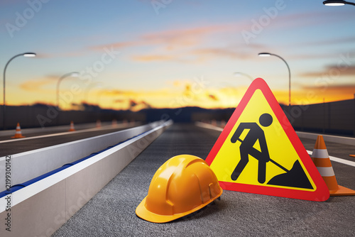 Road construction warning sign, safety helmet and traffic cones on highway at sunset with illuminated streetlights and empty roadway. 3D Rendering