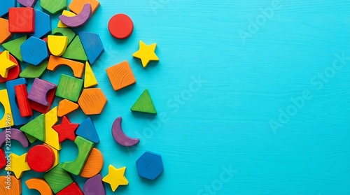 Colorful wooden geometric shape blocks collection on blue background