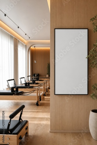 Blank vertical frame mockup in modern Pilates reformer studio