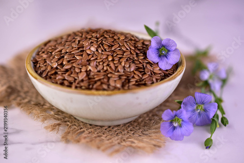 Flax seeds in a ceramic bowl. Superfood. Close-up.
