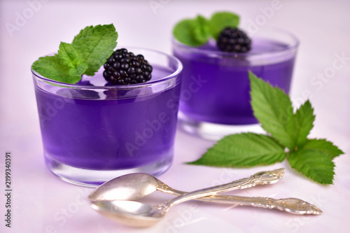 Картината върху платно Blackberry jelly in short glasses on a white background