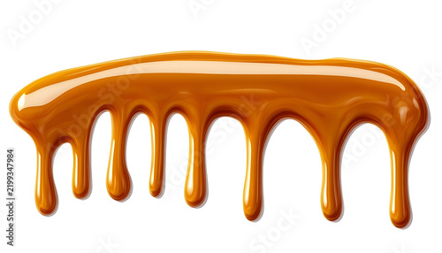 Golden caramel syrup dripping in slow motion creating sweet dessert topping and rich texture.