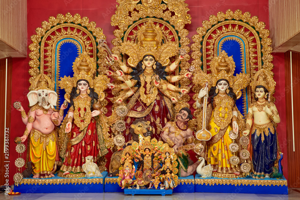 Fototapeta premium beautiful idol of Hindu Goddess Durga with sculpture of Laxmi, Ganesha, Saraswati and Kartikey, being worshipped inside a puja pandal. Shot during Durga puja festival in Kolkata. 