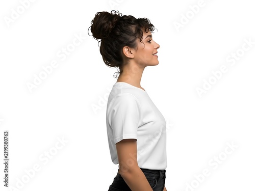 A young woman with curly hair standing in profile looking to the right