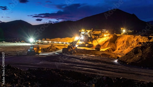 Industrial Mining Operation at Night with Heavy Machinery and Dramatic Lighting