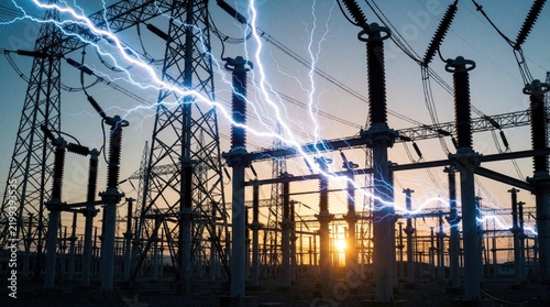 Electricity substation with lightning. Power lines and electrical grid infrastructure at sunset. Clean energy distribution and future grid resilience.