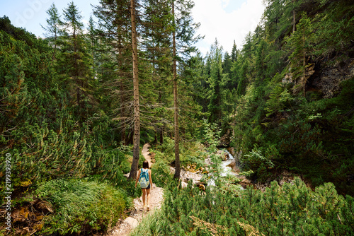 Woman hikes near Cascate di Fanes in the Dolomites. Italy